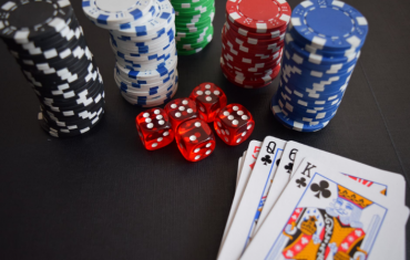 stacks of cards, dices, and chips